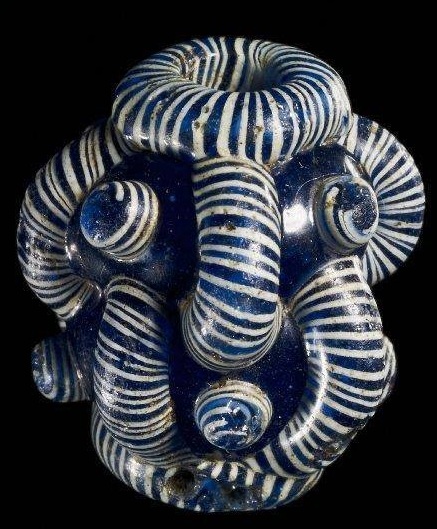 Late Iron Age glass 'face bead' from Antrim, Ireland. Such Celtic beads emerged in the early Iron Age, apparently based on Phoenician prototypes.